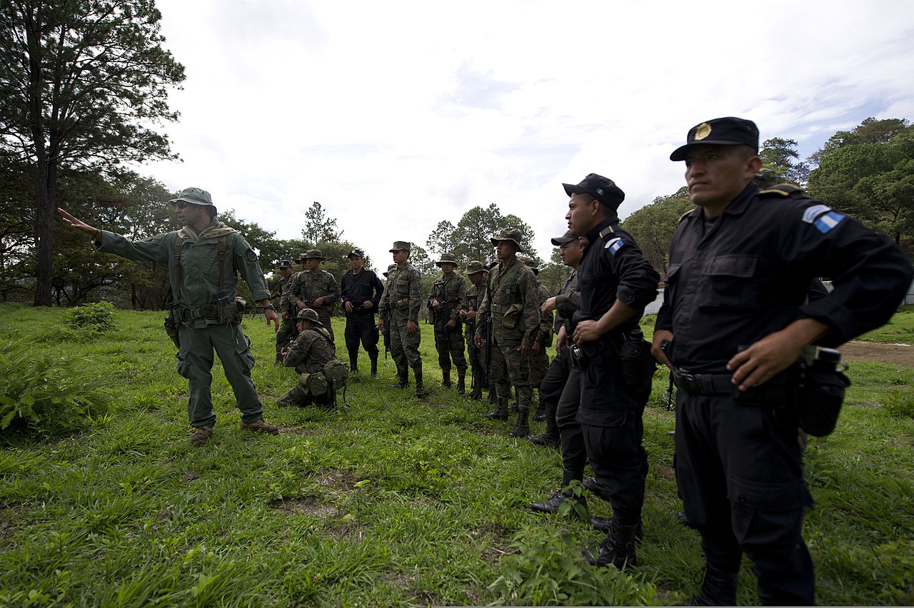 Agent Task Length Doubles Every Seven Months. The Reliable Version Is 18 Months Behind. — U.S. Border Patrol Agent Victor Cortez, left, explains to members of the Interagency Task Force Tecun Uman, comprised of Guatemalan police officers, soldiers, border patrol agents and customs agents 130612-A-TQ625-042