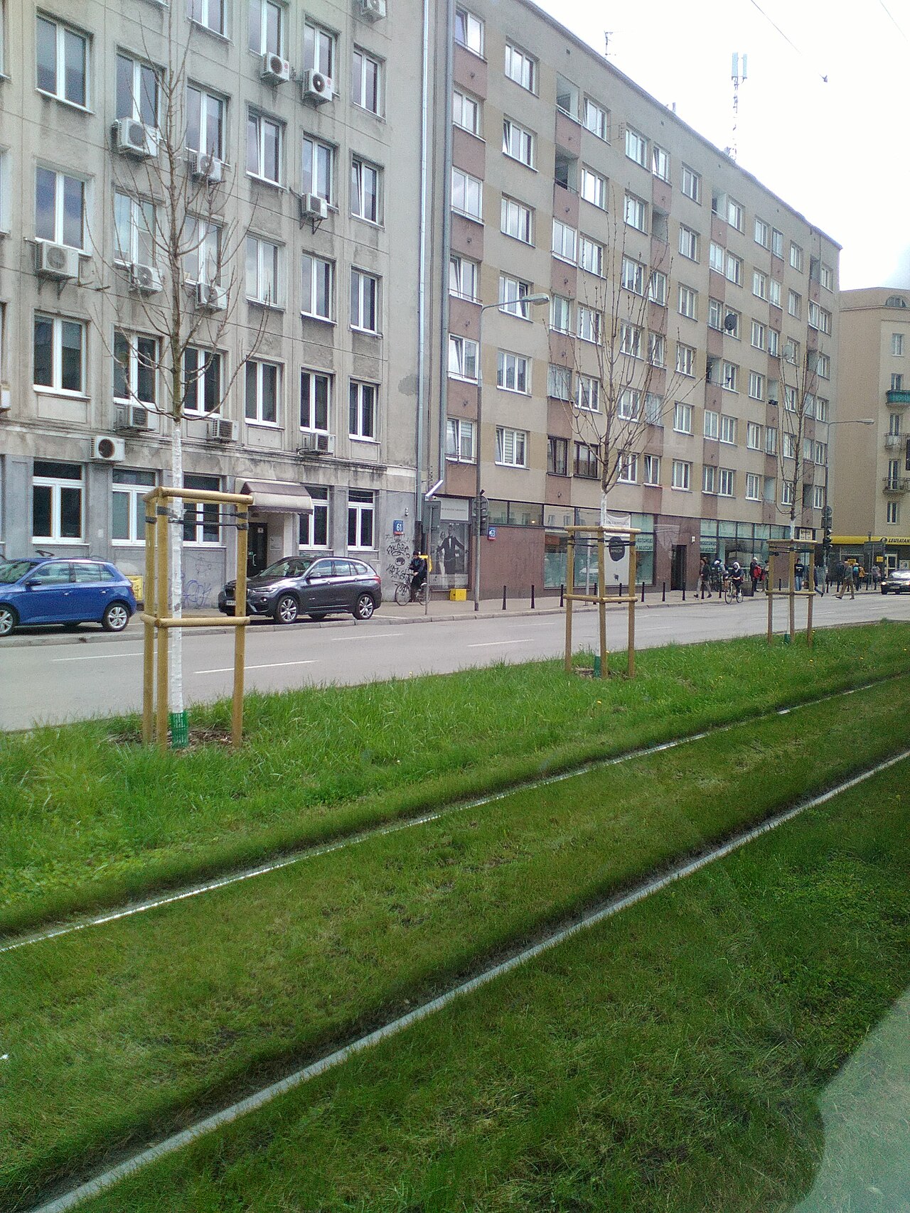 New Tool Tracks Public Predictions Using AI Infrastructure — Public transport grass-covered tram tracks in Warsaw 01