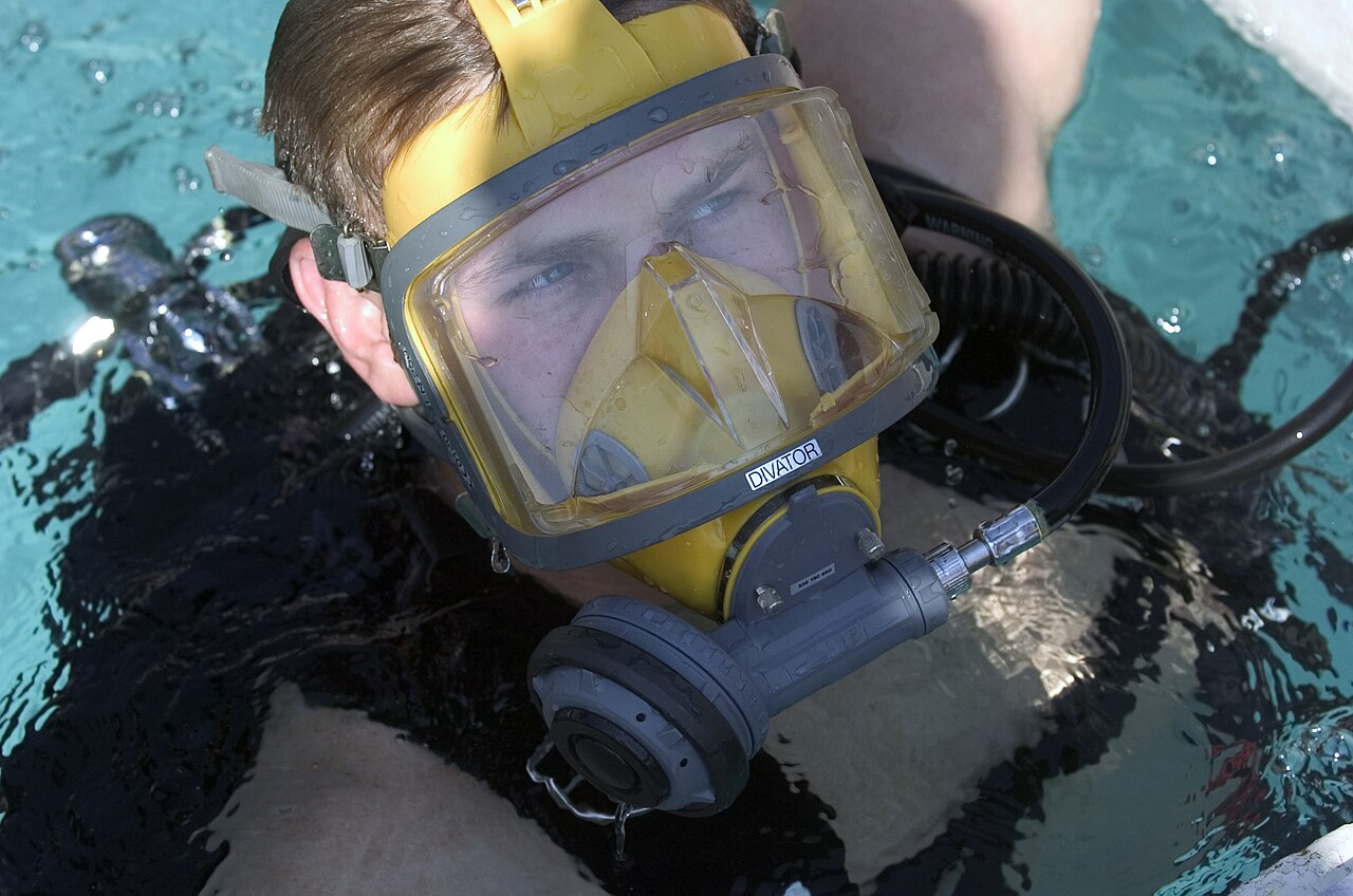 Lain Emerges as Structural Code Graph for Multi-Agent Coordination — US Navy 050727-N-0295M-010 Electrician's Mate 2nd Class Shane Portton emerges out of the Navy Diver-Explosive Ordnance Disposal (EOD) dive tank exhibit at the 2005 National Scout Jamboree held at Fort A.P. Hill, Va