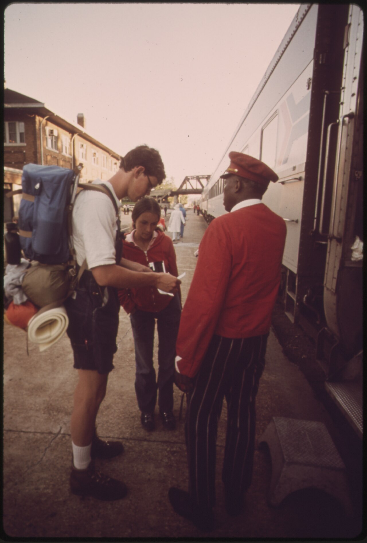 Dev Tools Builder Questions AI Anthropomorphism in Recent Research Review — PASSENGER CAR ATTENDANT ANSWERS QUESTIONS FOR PASSENGERS OF THE EMPIRE BUILDER AT A STOP AT LACROSSE, WISCONSIN, AS THE TRAIN IS ENROUTE FROM CHICAGO TO EAST GLACIER PARK, MONTANA, AND SEATTLE WASHINGTON. AMTRAK, SINCE IT ASSUMED MAJOR RESPONSIBILITY FOR U.S INTERCITY RAIL PASSENGER SERVICE IN 1971, HAS BEEN WORKING TO UPGRADE FACILITIES AND ATTRACT RIDERS