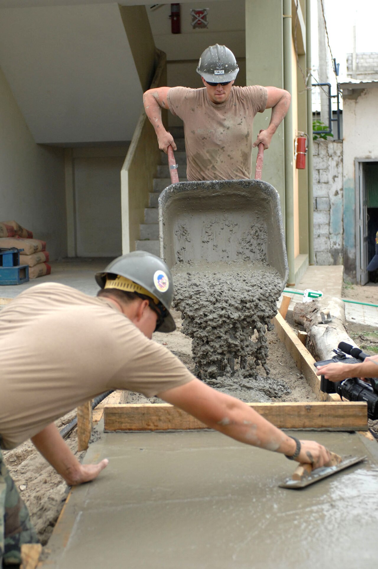 Builder Replaces Manual Email Triage With N8n LLM Workflow — US Navy 070817-N-0194K-024 Builder 2nd Class William Lathan and Builder 2nd Class Charles Page, both Seabees with Construction Battalion Maintenance Unit (CBMU) 202, build a sidewalk at Angelica Flores School