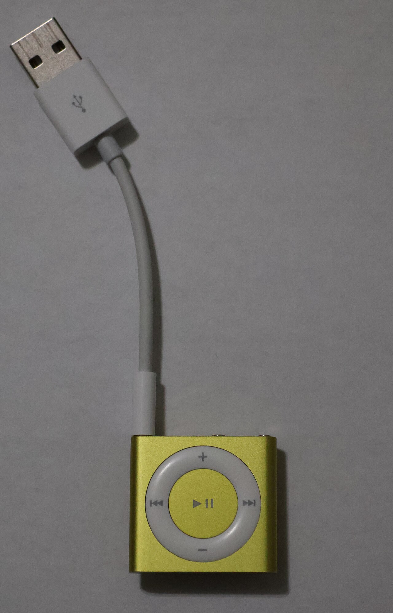Shuffle-and-Bisect Harness Exposes Hidden Agent Patch Defects — Yellow iPod Shuffle (Front – With USB Charger)